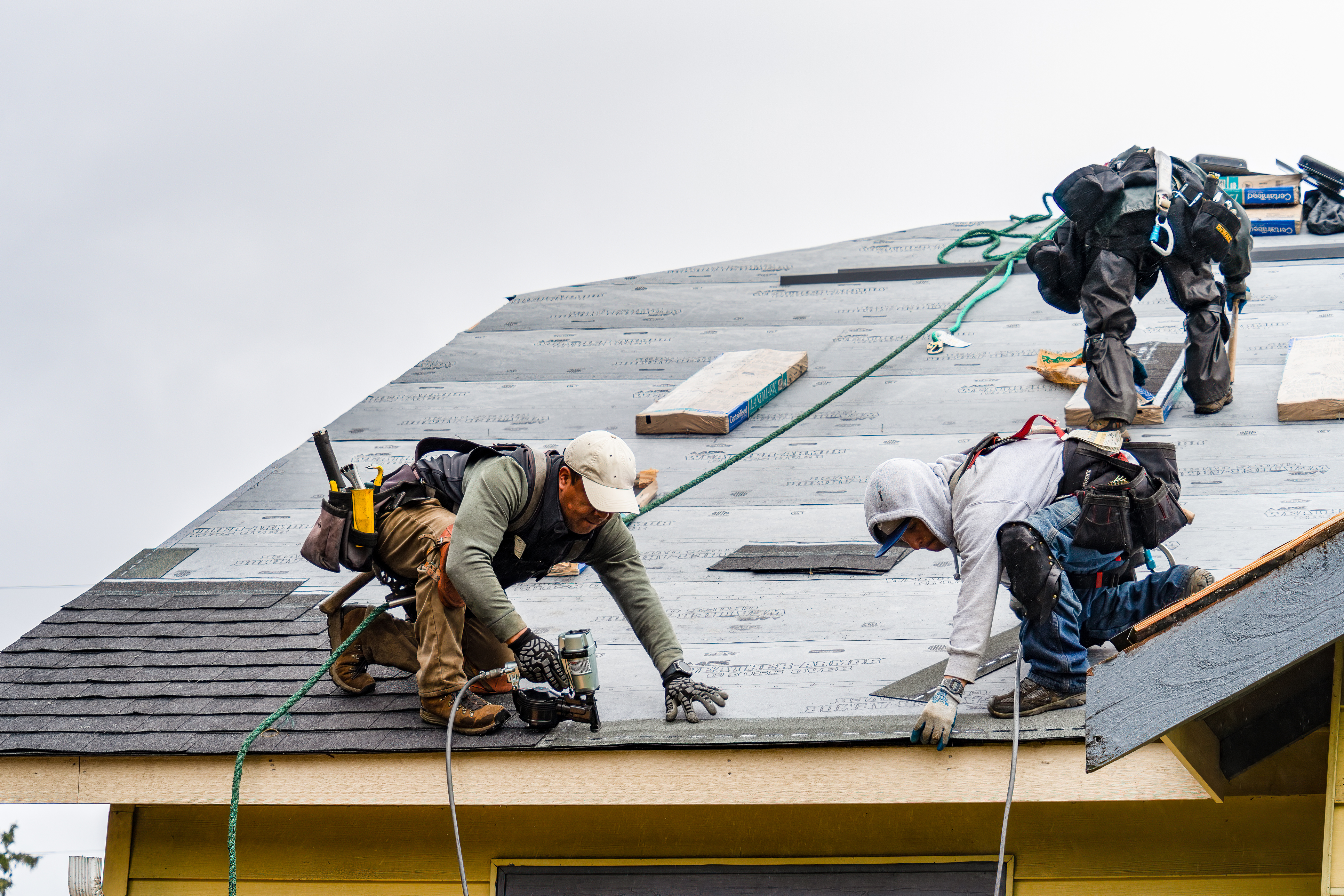 Amity Roofing crew installing shingles on a residential roof